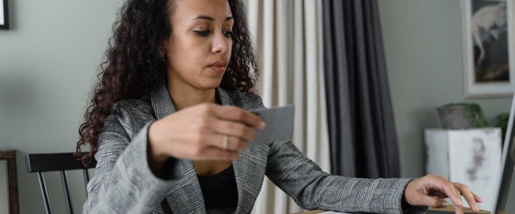 A person filling out an application form for a high interest savings account USA in-person.