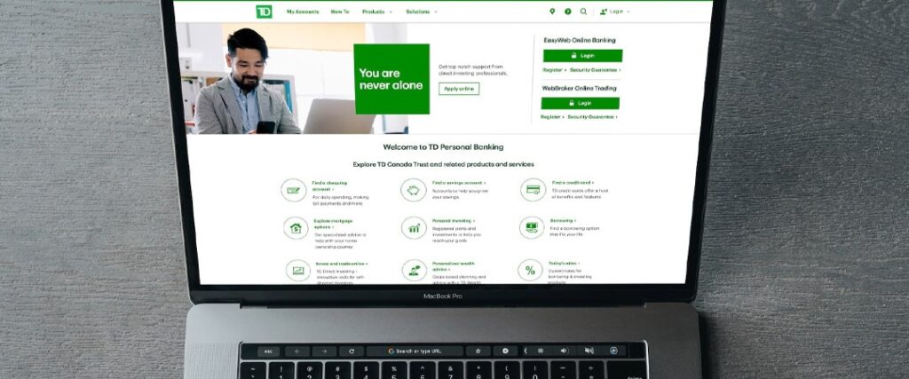 A person looking at a laptop with information about FDIC and NCUA insurance