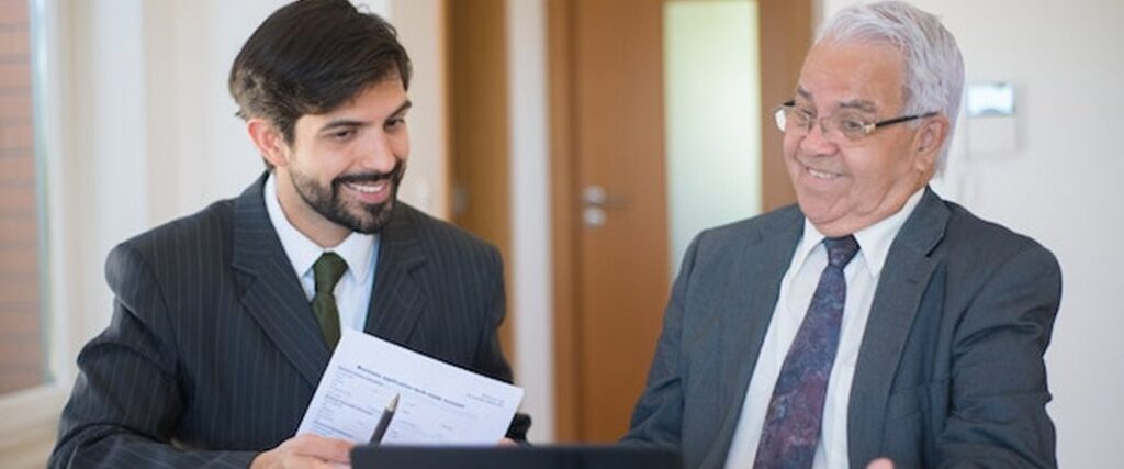 A person looking at a laptop with tips for maximizing high-interest savings account earnings